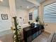 Stylish living area with modern decor, wood-look flooring, and a view of the home's entryway at 4132 Ancient Well Ct, Las Vegas, NV 89135