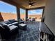 Relaxing covered patio with comfortable seating, ceiling fan, and outdoor dining area at 4132 Ancient Well Ct, Las Vegas, NV 89135