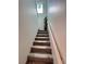 Carpeted stairs to the second floor featuring a handrail and a decorative window at 4132 Ancient Well Ct, Las Vegas, NV 89135