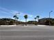 Street view of the neighborhood entrance featuring lush landscaping and well-maintained homes at 4132 Ancient Well Ct, Las Vegas, NV 89135