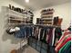 Bright walk-in closet showcasing organized shoe racks, hanging rods, and storage for clothing and accessories at 4132 Ancient Well Ct, Las Vegas, NV 89135