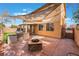 The backyard features an outdoor kitchen, fire pit, covered patio and privacy wall at 4133 Perfect Lure St, Las Vegas, NV 89129