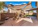 Outdoor living space with built-in grill, fire pit, and shade sails for entertaining at 4133 Perfect Lure St, Las Vegas, NV 89129