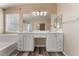 Bright bathroom with double vanity, soaking tub, and wood-look flooring at 4133 Perfect Lure St, Las Vegas, NV 89129