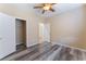 Neutral bedroom with wood-look floors, walk-in closet, and access to an attached bathroom at 4133 Perfect Lure St, Las Vegas, NV 89129