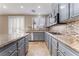 Well-lit kitchen features gray cabinets, granite countertops, stainless steel appliances, and decorative backsplash at 4133 Perfect Lure St, Las Vegas, NV 89129