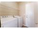 Functional laundry area featuring a washer, dryer, and convenient overhead storage shelf, perfect for simplifying chores at 4133 Perfect Lure St, Las Vegas, NV 89129