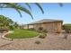 Backyard with artificial turf and desert landscaping at 4187 Pacifico Ln, Las Vegas, NV 89135