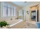 Bathroom boasts large soaking tub with decorative shutters at 4187 Pacifico Ln, Las Vegas, NV 89135