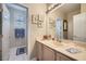 Bright bathroom with a neutral color scheme, framed art, and a well-lit vanity area at 4187 Pacifico Ln, Las Vegas, NV 89135