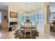 Charming dining area featuring plantation shutters and a decorative chandelier above a round dining table at 4187 Pacifico Ln, Las Vegas, NV 89135