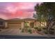 Inviting home exterior with desert landscaping, paver driveway, and a neutral color palette at 4187 Pacifico Ln, Las Vegas, NV 89135