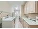 Bright laundry room with sink and storage at 4187 Pacifico Ln, Las Vegas, NV 89135
