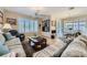 Comfortable living space with hardwood flooring, custom built-ins, and natural light from large windows with plantation shutters at 4187 Pacifico Ln, Las Vegas, NV 89135