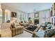 Cozy living room with a fireplace, plantation shutters, neutral walls, and comfortable seating arrangement at 4187 Pacifico Ln, Las Vegas, NV 89135