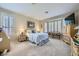 Serene primary bedroom with plush carpet, soft lighting, and a cozy window seat beneath plantation shutters at 4187 Pacifico Ln, Las Vegas, NV 89135