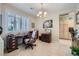 Well-lit office space with tiled floor, plantation shutters, and a classic wooden desk and cabinetry at 4187 Pacifico Ln, Las Vegas, NV 89135