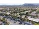 Wide aerial shot of the community, highlighting the house with a pool, and putting green at 4594 Blue Mesa Way, Las Vegas, NV 89129