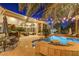 Backyard patio with a table, BBQ, seating and access to a pool with lights and spa at 4594 Blue Mesa Way, Las Vegas, NV 89129