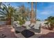 Backyard patio area featuring outdoor seating with comfortable cushions and pillows at 4594 Blue Mesa Way, Las Vegas, NV 89129