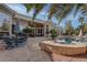 Backyard patio with stone floors, outdoor dining, a lounge area, and a sparkling pool with spa at 4594 Blue Mesa Way, Las Vegas, NV 89129