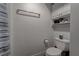 Well lit bathroom featuring a toilet, towel rack, and storage shelving at 4594 Blue Mesa Way, Las Vegas, NV 89129