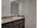 Chic half-bathroom featuring stylish vanity with granite countertop and modern fixtures at 4594 Blue Mesa Way, Las Vegas, NV 89129