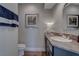 Inviting half-bathroom with stylish vanity, granite countertop, and ample lighting at 4594 Blue Mesa Way, Las Vegas, NV 89129