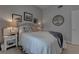 Bright bedroom with a comfy bed, a nightstand, and framed pictures hanging on the wall at 4594 Blue Mesa Way, Las Vegas, NV 89129