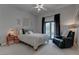 Cozy bedroom featuring a ceiling fan, a comfy chair, and natural light at 4594 Blue Mesa Way, Las Vegas, NV 89129