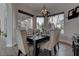 Elegant dining room with modern chandelier and seating for six, lit naturally at 4594 Blue Mesa Way, Las Vegas, NV 89129