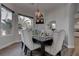 Sophisticated dining room with modern chandelier and seating for six, lit naturally at 4594 Blue Mesa Way, Las Vegas, NV 89129