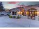 Charming home exterior with iron gate, beautiful landscaping, and welcoming facade at 4594 Blue Mesa Way, Las Vegas, NV 89129