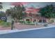 This desert home boasts an expansive circular driveway, lush landscaping, and an ornate gated entrance, perfect for curb appeal at 4594 Blue Mesa Way, Las Vegas, NV 89129