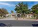 This home offers mature landscaping and a circular driveway, complete with a mature shade tree, creating curb appeal at 4594 Blue Mesa Way, Las Vegas, NV 89129