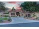 Expansive front exterior of a desert home features manicured landscaping and a circular driveway leading to a stately entrance at 4594 Blue Mesa Way, Las Vegas, NV 89129