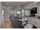 The expansive kitchen features a central island with granite countertops and stainless appliances at 4594 Blue Mesa Way, Las Vegas, NV 89129