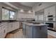Spacious kitchen with stainless steel appliances, a large island, and granite countertops at 4594 Blue Mesa Way, Las Vegas, NV 89129
