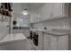 Well-organized laundry room featuring ample storage and modern appliances at 4594 Blue Mesa Way, Las Vegas, NV 89129