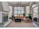 Bright living room featuring a fireplace and floor-to-ceiling windows with desert views at 4594 Blue Mesa Way, Las Vegas, NV 89129
