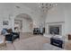 Spacious living room with fireplace, modern lighting, arched entryway, and stylish decor at 4594 Blue Mesa Way, Las Vegas, NV 89129