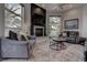 Modern living room featuring a fireplace, TV, and comfortable seating with palm tree views at 4594 Blue Mesa Way, Las Vegas, NV 89129