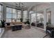 Bright living room featuring floor-to-ceiling windows, modern lighting, and comfortable seating area at 4594 Blue Mesa Way, Las Vegas, NV 89129