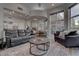 Open-concept living room with stylish seating, a dining area and outdoor access at 4594 Blue Mesa Way, Las Vegas, NV 89129
