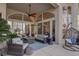 Inviting outdoor living space with comfortable seating, palm trees, and a ceiling fan at 4594 Blue Mesa Way, Las Vegas, NV 89129