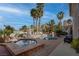 Resort-style backyard featuring a sparkling pool, hot tub, palm trees, and lounge chairs at 4594 Blue Mesa Way, Las Vegas, NV 89129