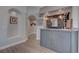 The well-appointed wet bar includes tile, granite countertops, a sink, and a wine rack at 4594 Blue Mesa Way, Las Vegas, NV 89129