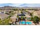 An aerial view displays the home's pool, desert landscaping, and mountain views at 4624 Leon De Oro Dr, Las Vegas, NV 89129