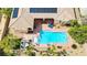 Aerial view showcases a backyard oasis with a pool, lounge area, and mature landscaping at 4624 Leon De Oro Dr, Las Vegas, NV 89129