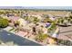 Aerial view of a home with solar panels, desert landscaping, and a three-car garage at 4624 Leon De Oro Dr, Las Vegas, NV 89129